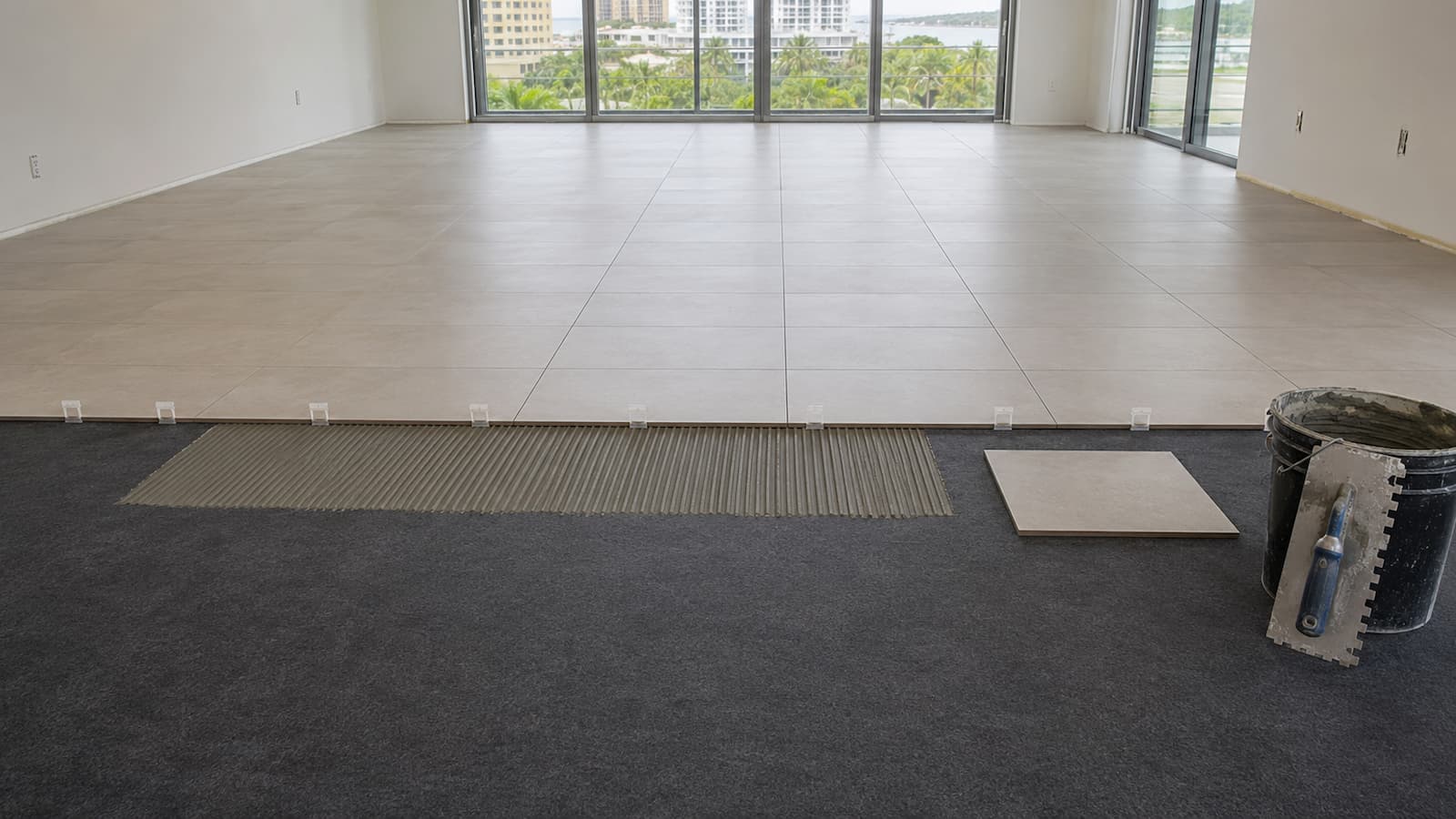 Condo Tile Acoustic Membrane Installation Porcelain condo tile being installed over a bonded acoustic membrane on concrete